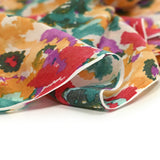 Voile polycoton imprimé taches de couleur turquoise, rouge et orange