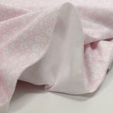 Piqué de coton imprimé fleurs printanière fond rose clair