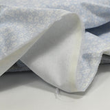 Piqué de coton imprimé fleurs printanière fond bleu clair