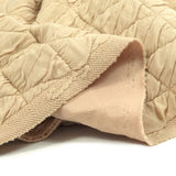 Jersey matelassé triangle fond beige clair