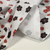 Coton imprimé marguerite noir et rouge fond blanc