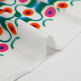 Viscose imprimée agitation verte et orange fond blanc