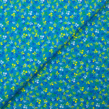 Popeline de coton imprimée bourgeon jaune et bleu fond turquoise