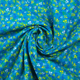 Popeline de coton imprimée bourgeon jaune et bleu fond turquoise