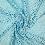 Dentelle polyester chevron blanc fond turquoise
