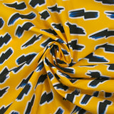 Popelín de algodón ORGÁNICO estampado con fondo amarillo rayo
