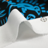 Light cotton satin with blue and orange graffiti print, black background