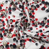 Satin de coton élasthanne dans les bulles rouge fond blanc