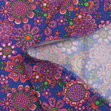 Cotton corduroy printed with psychedelic flowers indigo background