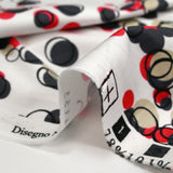 Satin de coton élasthanne dans les bulles rouge fond blanc