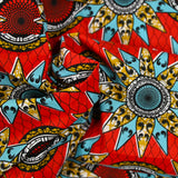 Coton imprimé ethnique Eindhoven bleu et ocre fond rouge