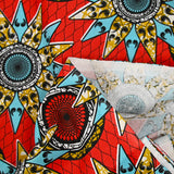 Coton imprimé ethnique Eindhoven bleu et ocre fond rouge
