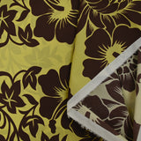 Cotton printed with giant brown flowers on anise green background