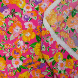Viscose imprimée fleurs orange fond fuchsia