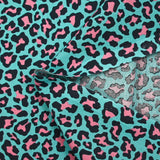 Coton imprimé léopard rose fond turquoise