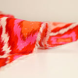 Viscose imprimée losange rose fond rouge