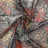 Mousseline imprimée lurex feu d'artifice brique et ocre fond noir