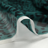 Mousseline crinkle 100% soie imprimée graou fond bleu canard
