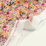 Coton imprimé Matilde fleurs orange et fuchsia au mètre