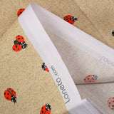 Polycoton imprimé coccinelle fond ficelle