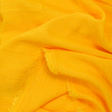 Crépon viscose rayé lurex doré fond mangue