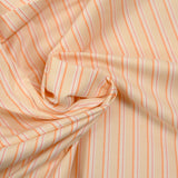 Popeline de coton tissée-teinte rayée orange fond pêche