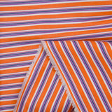 Popelín de algodón tejido teñido a rayas naranjas y moradas