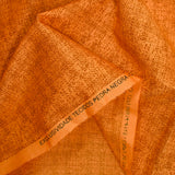 Coton imprimé empreinte fond orange foncé