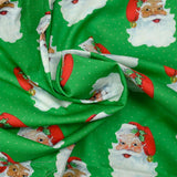 Coton imprimé père Noël à pois fond vert