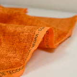 Coton imprimé empreinte fond orange foncé
