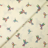 Coton imprimé envolée de colibris fond écru