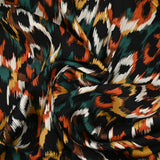 Satin de viscose imprimé Vénus orange brûlé fond noir