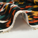Satin de viscose imprimé Vénus orange brûlé fond noir