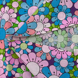 Coton imprimé flower power parme fond violet