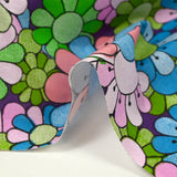 Coton imprimé flower power parme fond violet