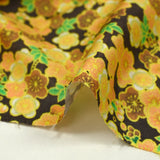 Cotton printed with yellow cherry blossoms, brown background