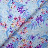 Cotton poplin printed with the shade of ferns on a baby blue background