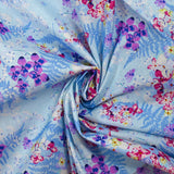 Cotton poplin printed with the shade of ferns on a baby blue background