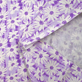 Popeline de coton imprimée vibration de marguerite fond violet