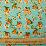 Popeline de coton imprimée bouquet orange fond vert d'eau
