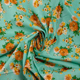 Popeline de coton imprimée bouquet orange fond vert d'eau