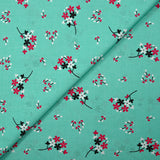 Popeline de coton imprimée souffle fleuri fond aqua
