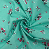 Popeline de coton imprimée souffle fleuri fond aqua