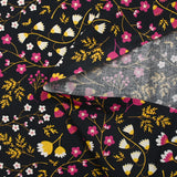 Popeline de coton imprimée tiges de fleurs jaune et fuchsia fond noir