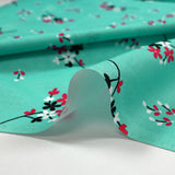 Popeline de coton imprimée souffle fleuri fond aqua
