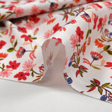 Popeline de coton imprimée fleurette dans le vent rouge fond blanc