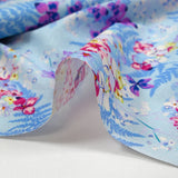 Cotton poplin printed with the shade of ferns on a baby blue background