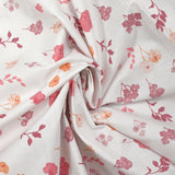 Popeline de coton imprimée poésie florale rose fond blanc
