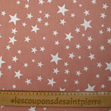 Popeline de coton imprimée étoiles fond vieux rose