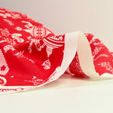 Popeline de coton imprimée pampille de Noël fond rouge